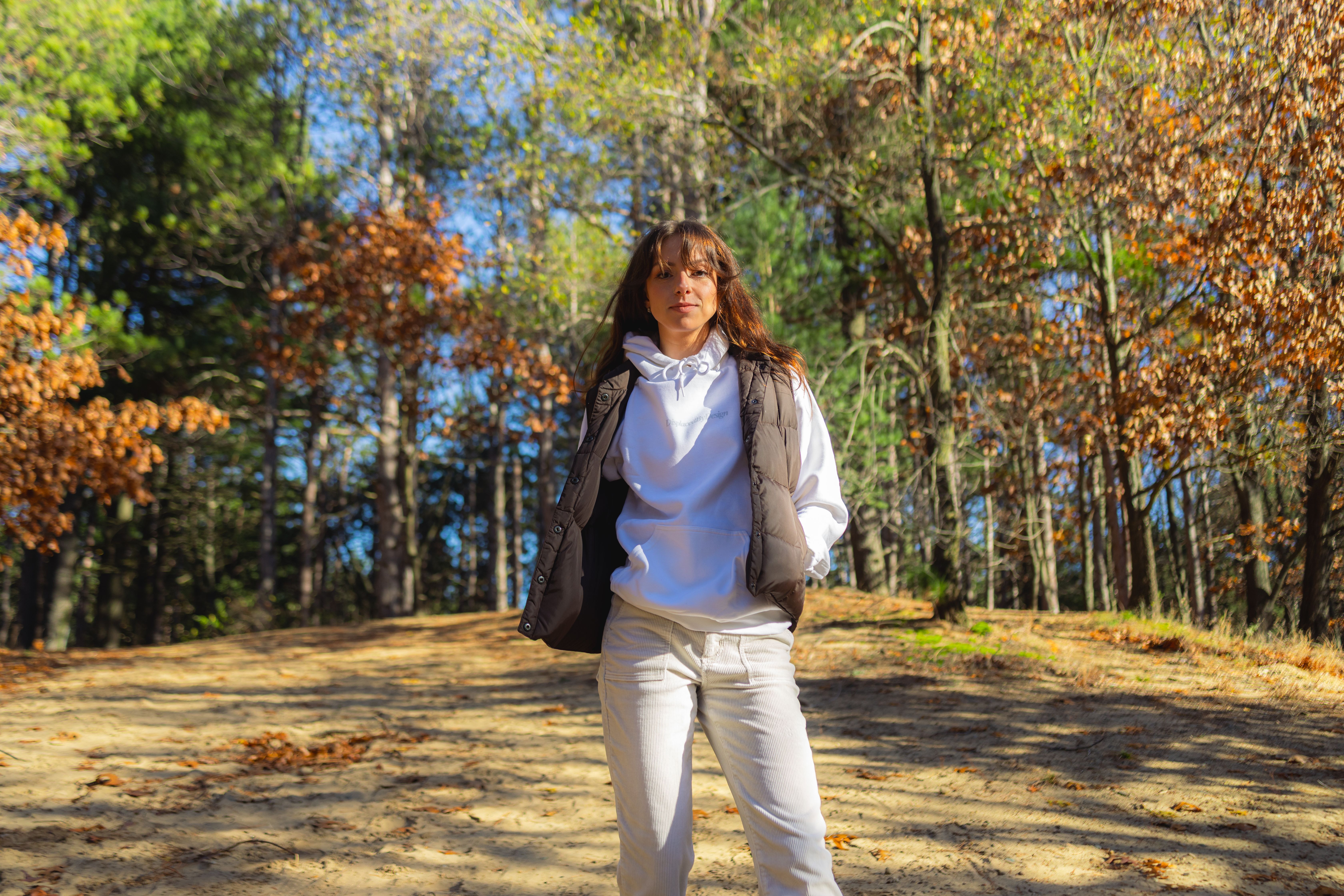 Woman Walking Through Autumn Forest Path · Free Stock Photo
