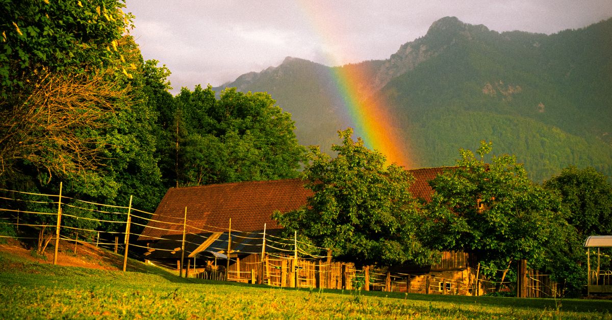 Beautiful Farm Landscape with Rainbow and Mountains · Free Stock Photo