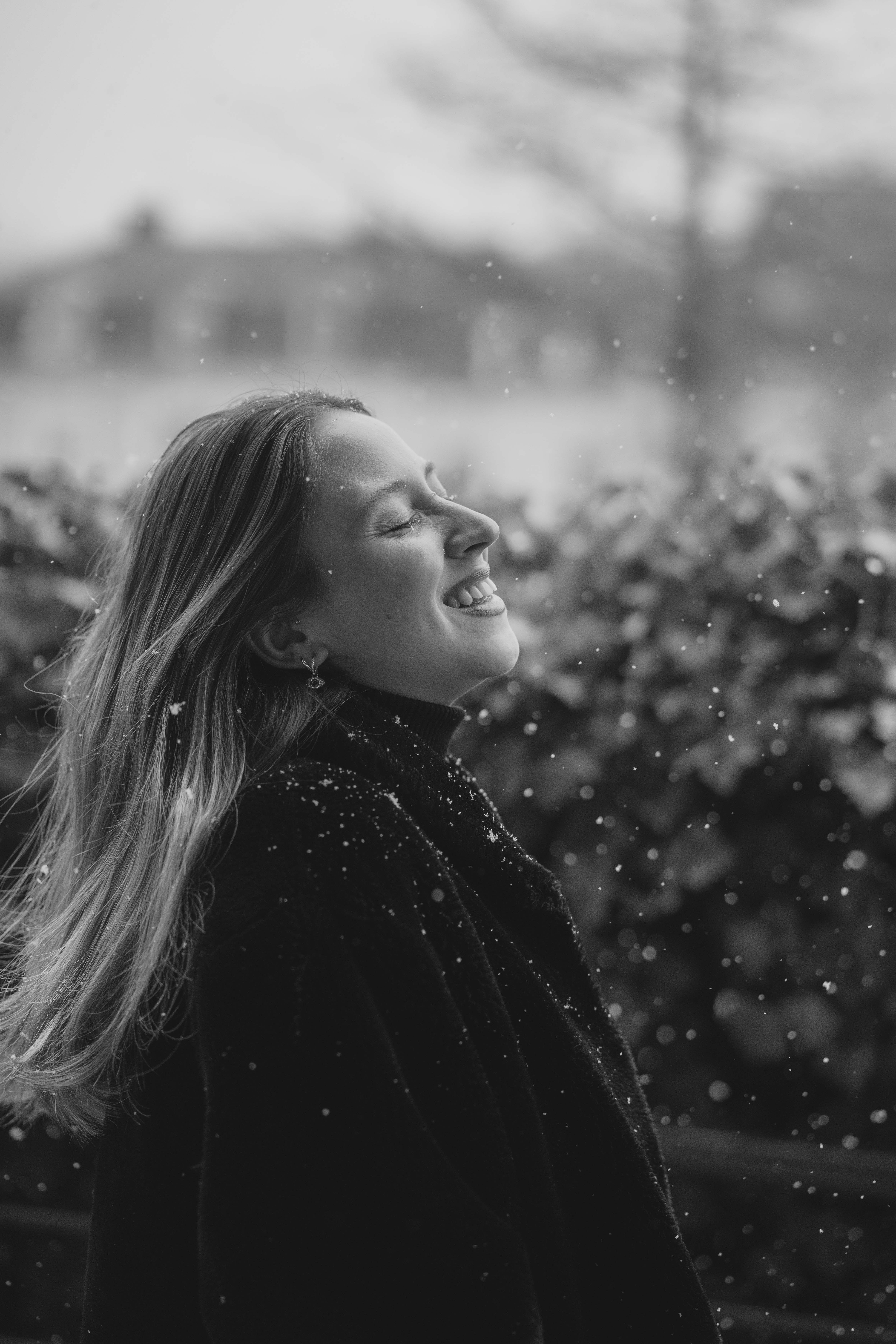 Woman Enjoying a Snowfall in Black and White · Free Stock Photo