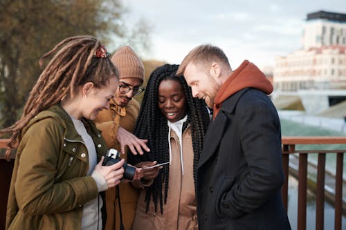 Photo Of People Looking At Photograph