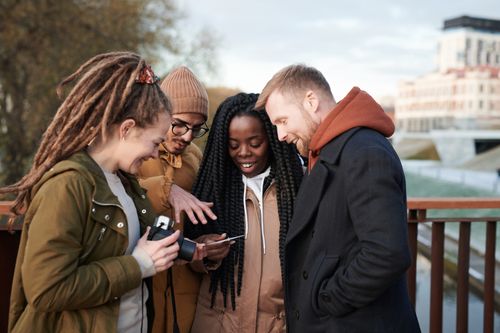 Free Friends sharing a moment outdoors in winter attire, smiling and happy. Stock Photo