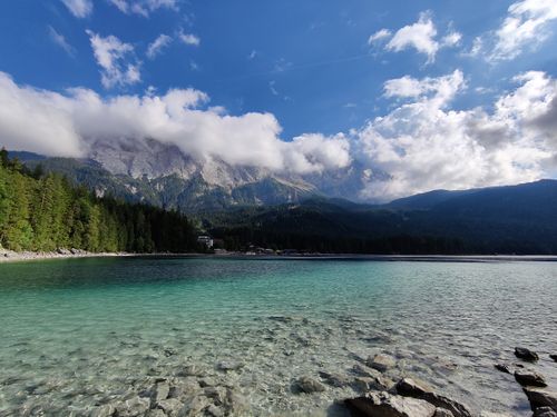 Free Crystalline Eibsee under the Bavarian Alps with turquoise waters and majestic mountains. Stock Photo