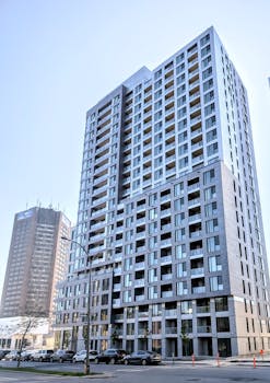 A sleek modern high-rise building in downtown Montréal, showcasing contemporary architecture.