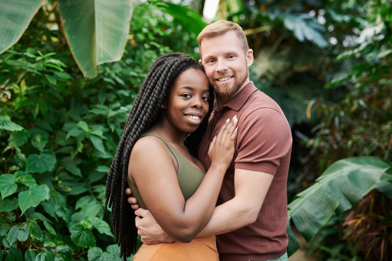 Couple smiling and hugging in a garden