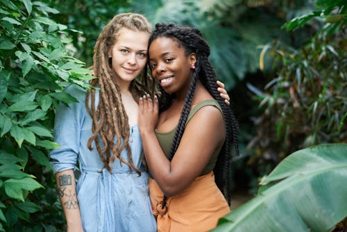 Photo Of Women Standing Near Plants