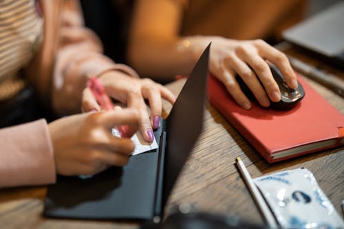 Selective Focus Photo of Person Holding a Mouse