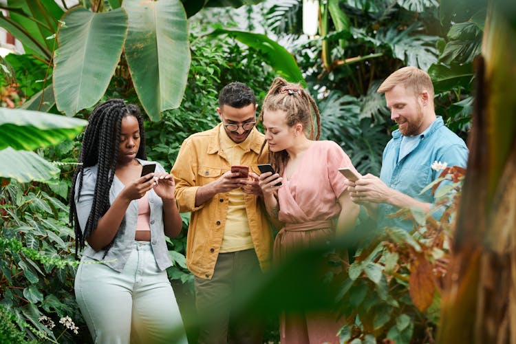 Photo Of People Holding Their Phones