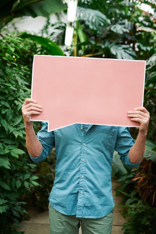 Photo Of Man Holding Signage