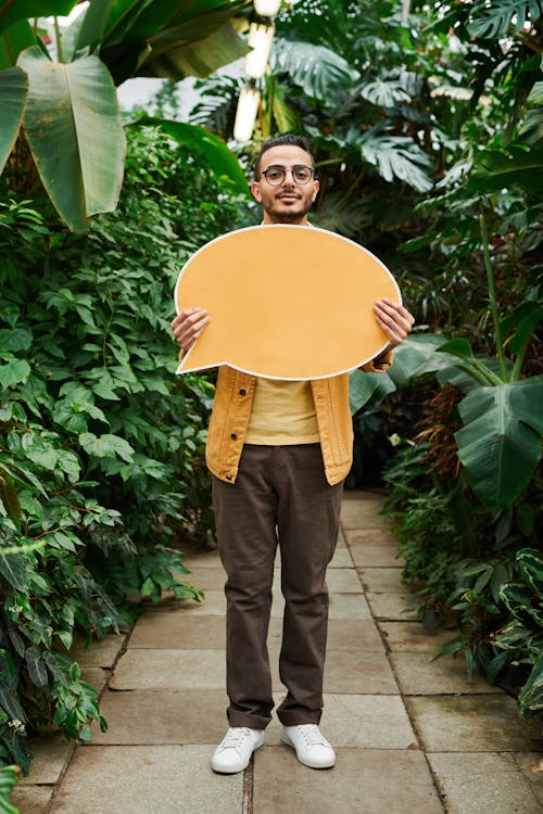 Photo Of Man Holding Yellow Message Board