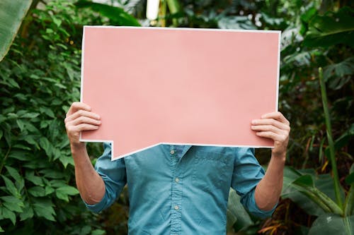 Photo of Person Holding Blank Signboard