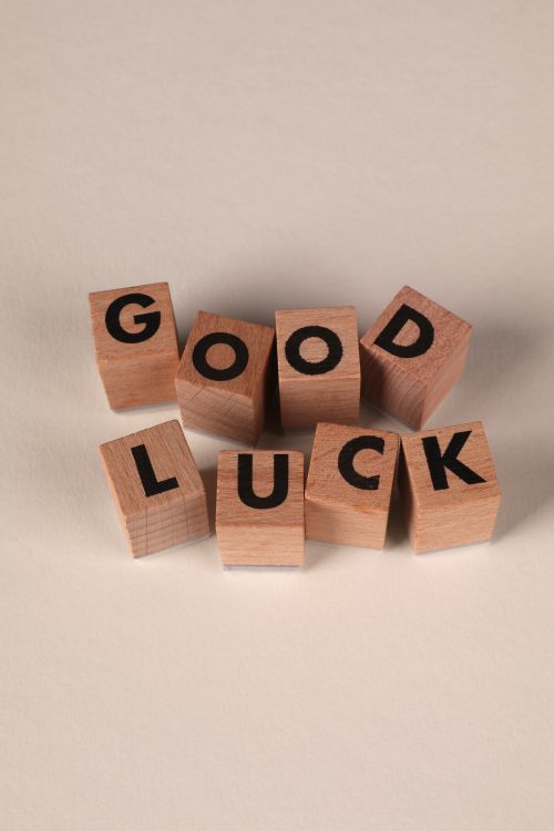 Free Wooden blocks arranged to spell 'Good Luck' on a neutral background. Perfect for positivity themes. Stock Photo
