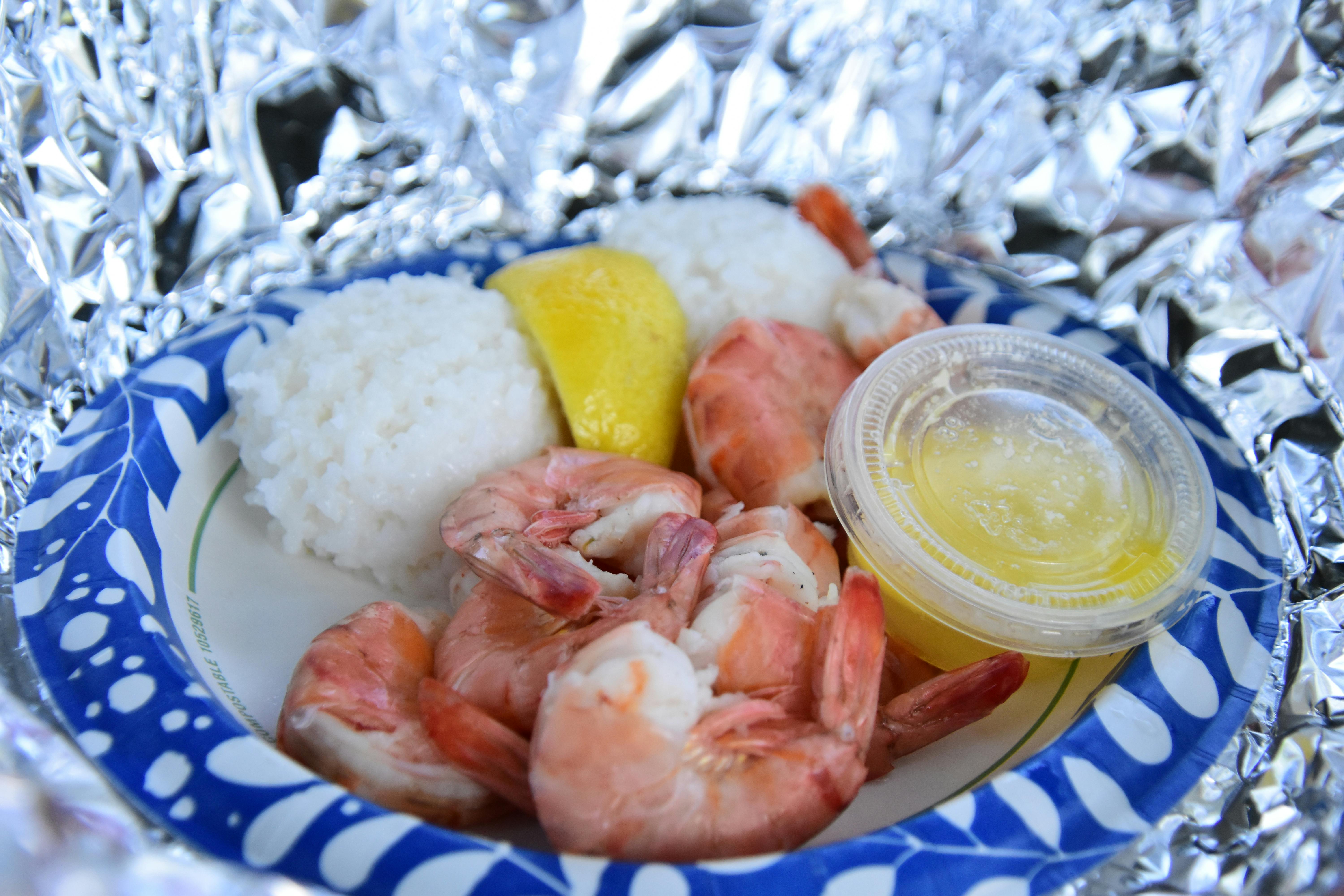 golden smashed potatoes with garlic butter shrimp and a lemon wedge