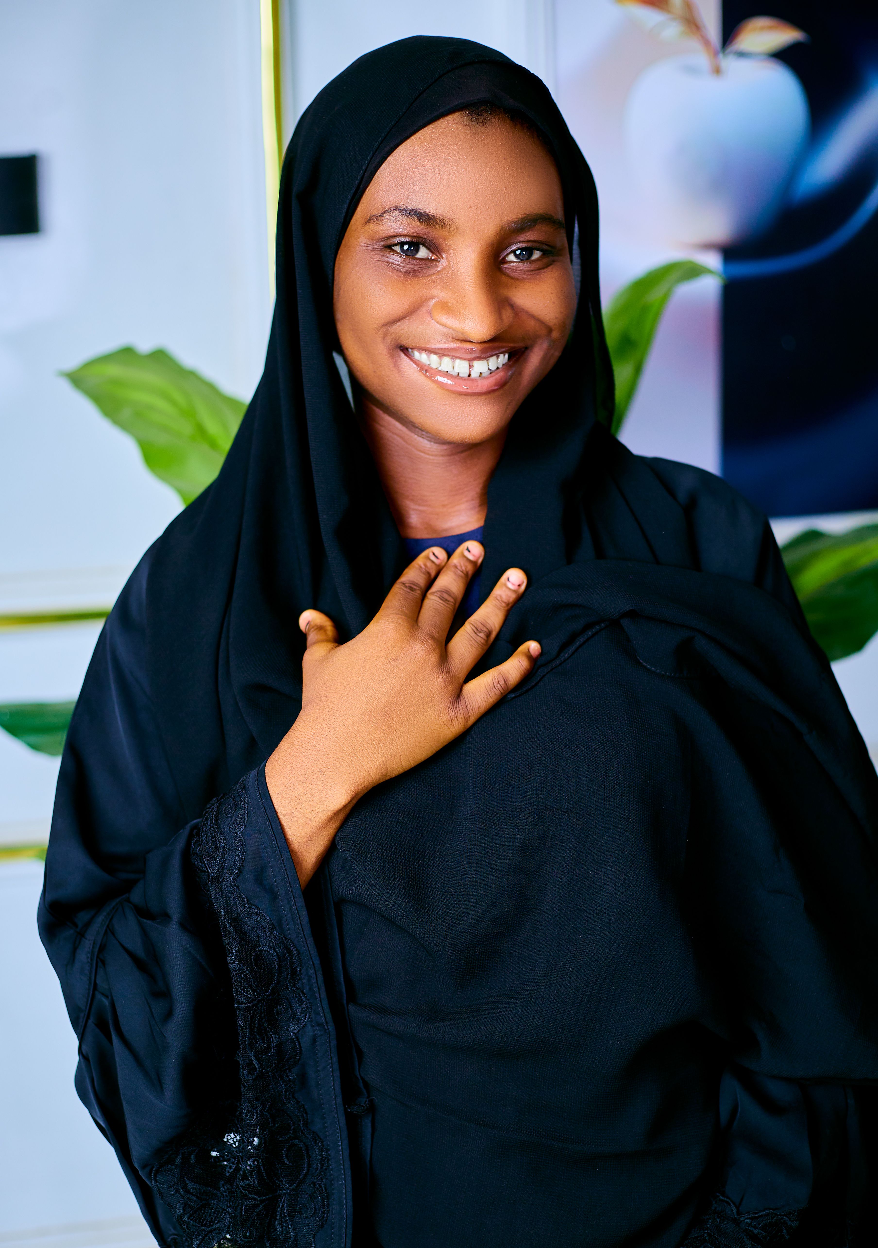 Portrait of Smiling Woman in Black Hijab Indoors · Free Stock Photo