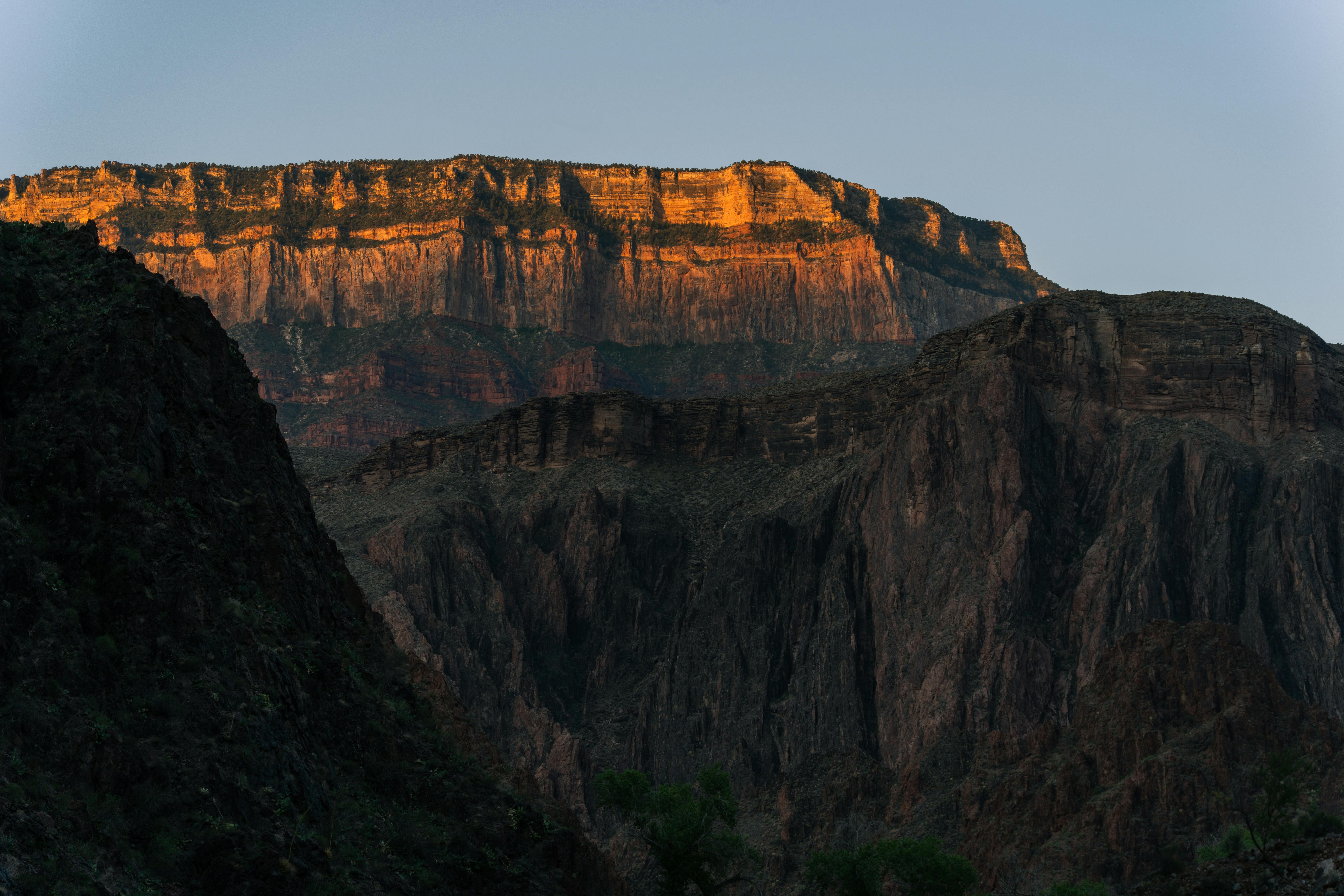 Majestic view of the Grand Canyon at sunset, capturing layered rock formations in Arizona.