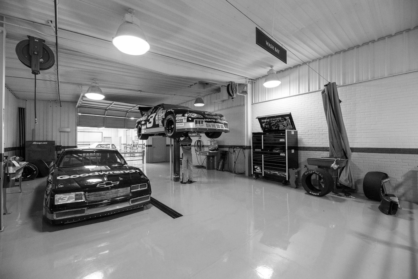 Classic race car in a vintage workshop.