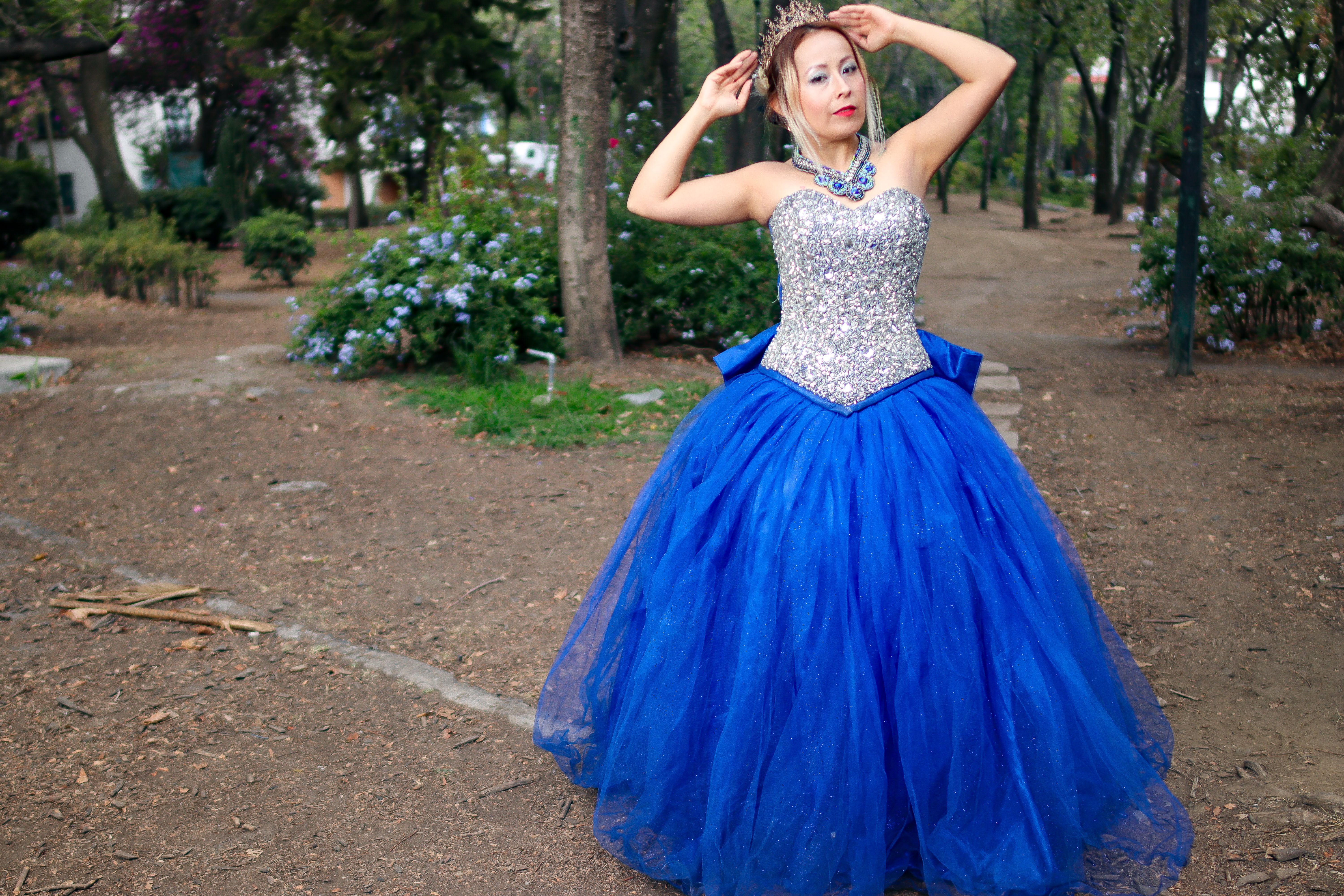 Elegant Woman Posing in Sparkling Blue Gown Outdoors · Free Stock Photo