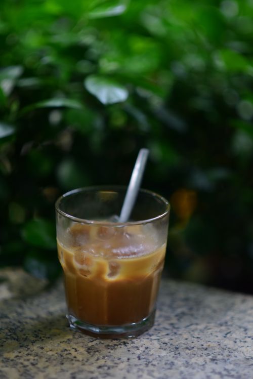 Free Refreshing iced coffee in a glass sits on a stone table, perfect for a hot summer's day. Stock Photo