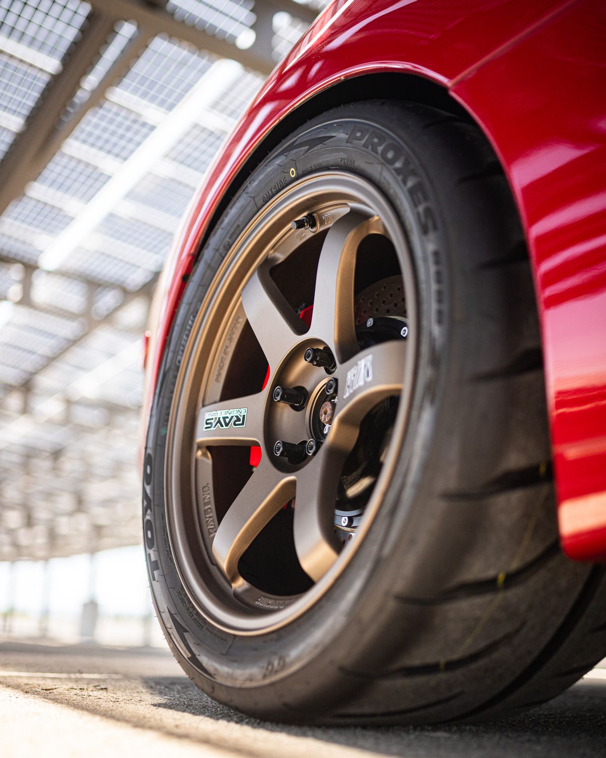 Closed Rims Close-Up of Red Sports Car Wheel with Alloy Rims · Free Stock Photo
