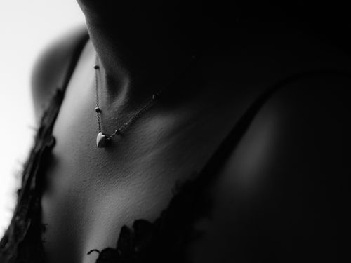 Free Artistic black and white portrait highlighting a delicate necklace on a woman's neck. Stock Photo