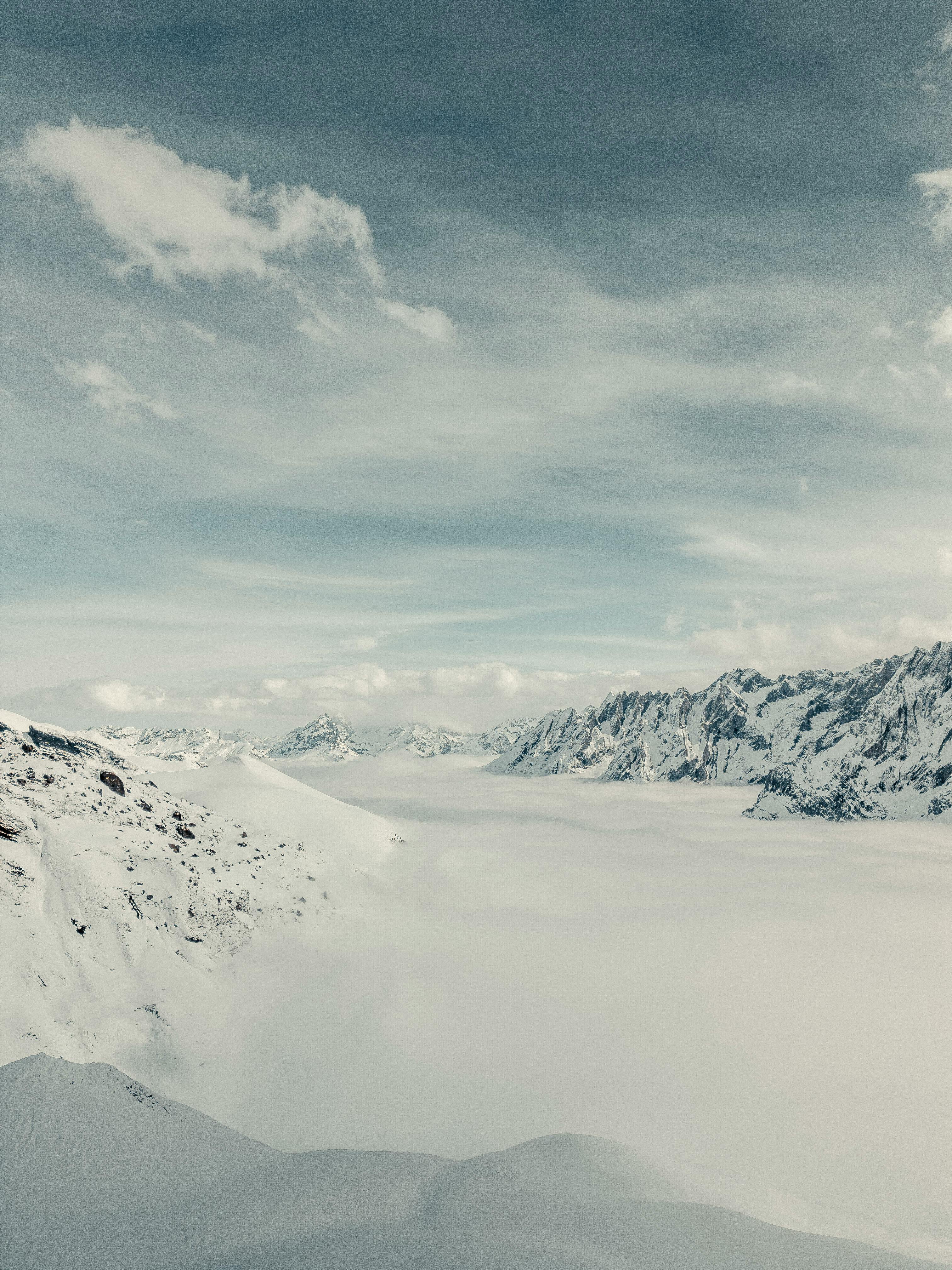 Majestic view of the snowy Swiss Alps with dramatic sky and vast snowfield.