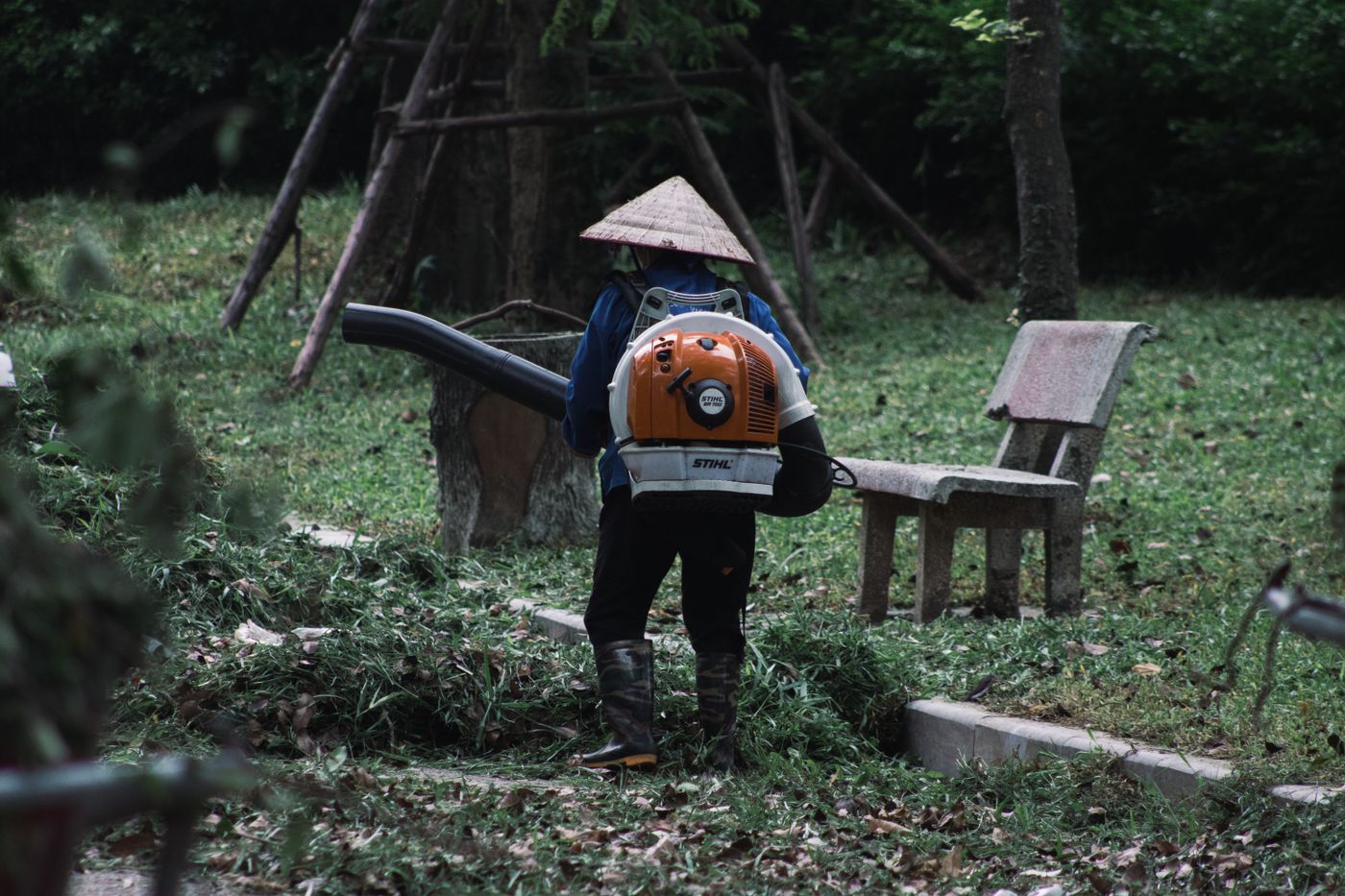 Gardener using a leaf blower