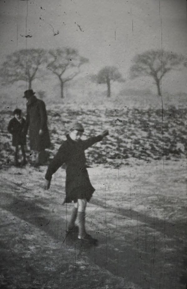 Old Photo Of Child Playing On Ice During Winter