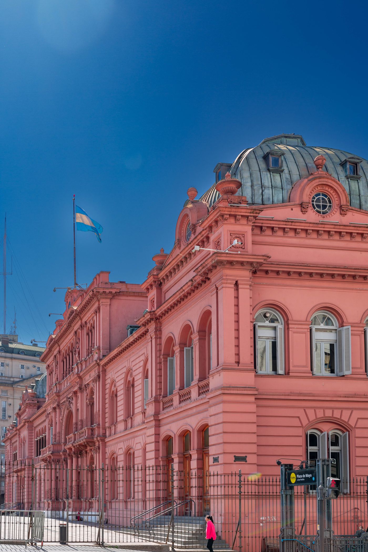 The pink Casa Rosada presidential palace on Plaza de Mayo under a blue sky, Buenos Aires, Argentina