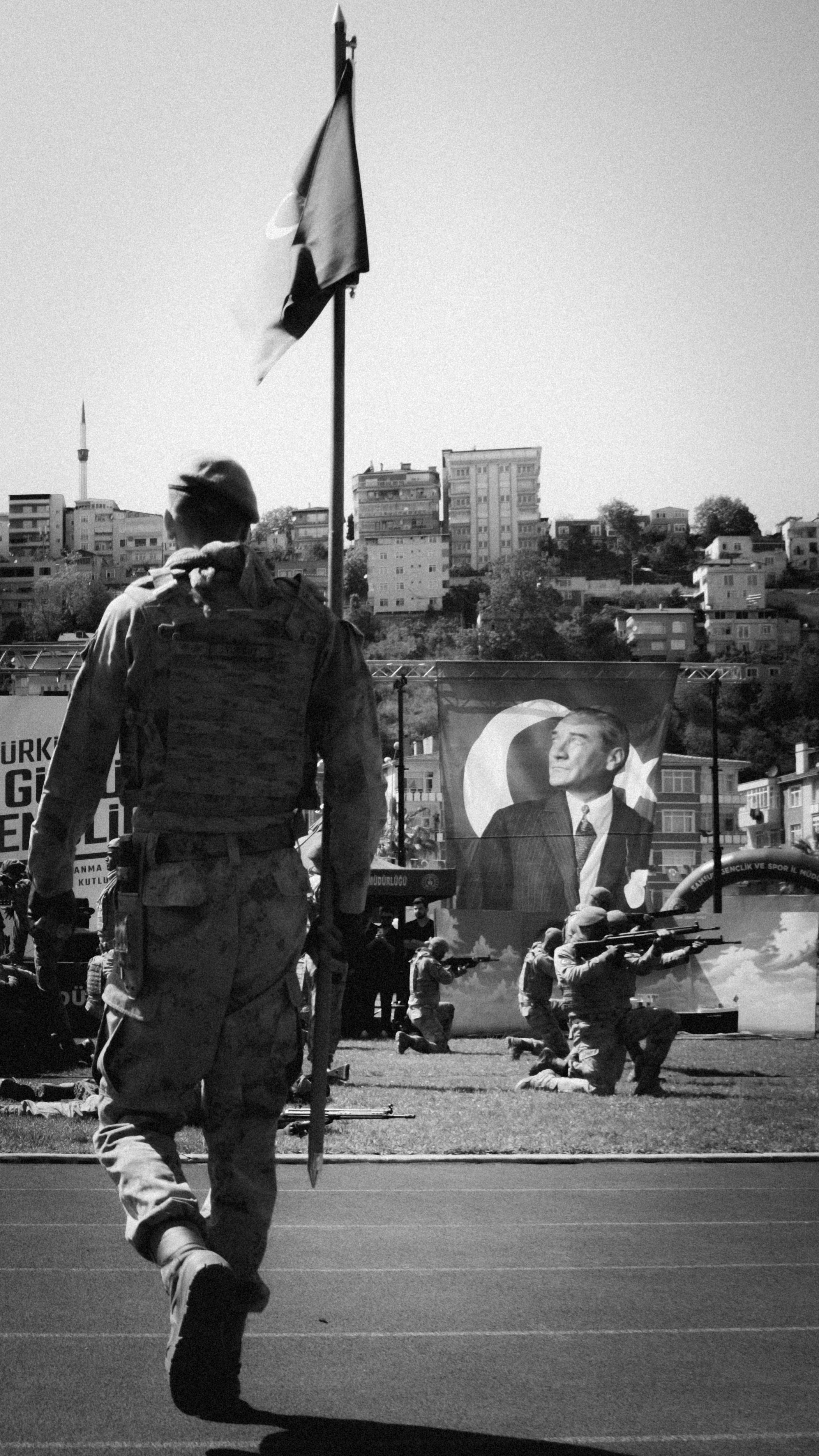 Soldier holding a flag with urban backdrop and iconic imagery.
