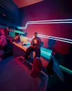 Man in Neon-Lit Room with Futuristic Theme