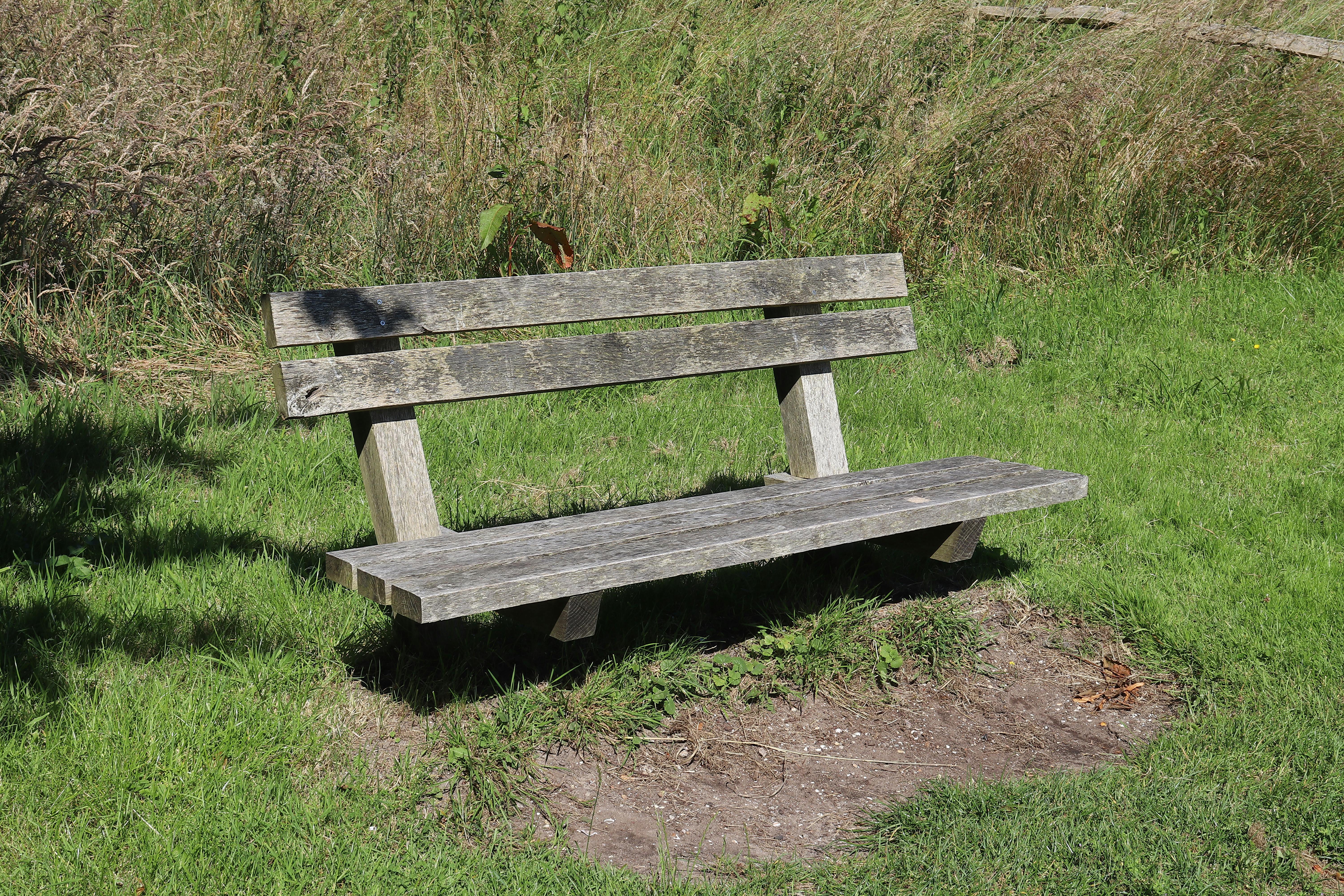 Parent Sitting Quietly On A Bench While A Toddler Has A Tantrum Nearby In A Public Setting