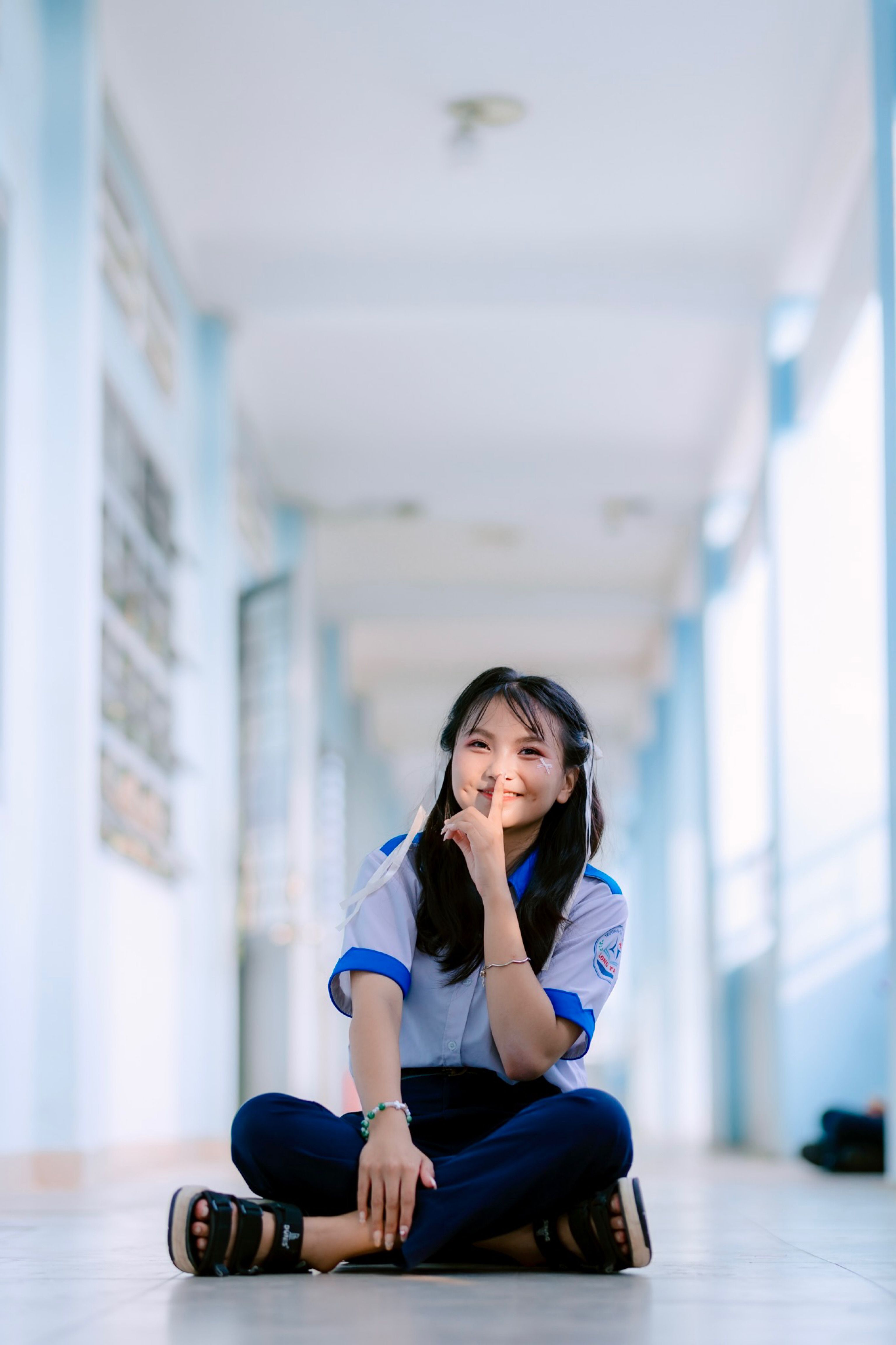 Young Woman Smiling in School Corridor