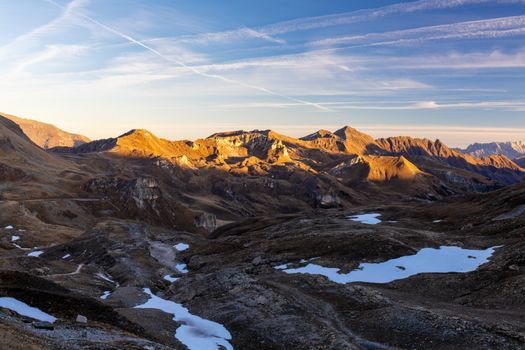 Captivating view of Korutany mountains at sunset with patches of snow and a vibrant sky.