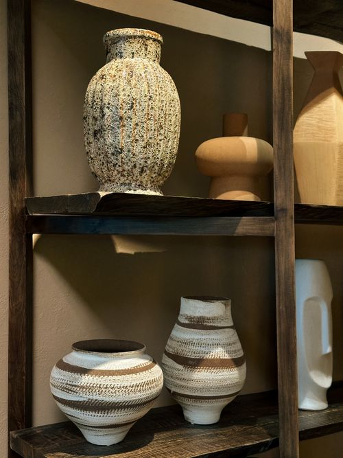 Free Artisan ceramic vases displayed on rustic wooden shelves in Da Nang, Vietnam. Stock Photo