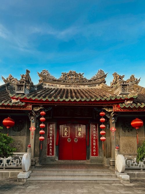 Free Beautiful Chinese temple in Hội An, Vietnam adorned with red lanterns and intricate carvings. Stock Photo