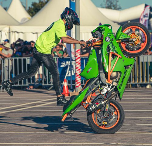 Free Dynamic stunt performer doing a wheelie on Kawasaki bike in Oran, Algeria. Stock Photo