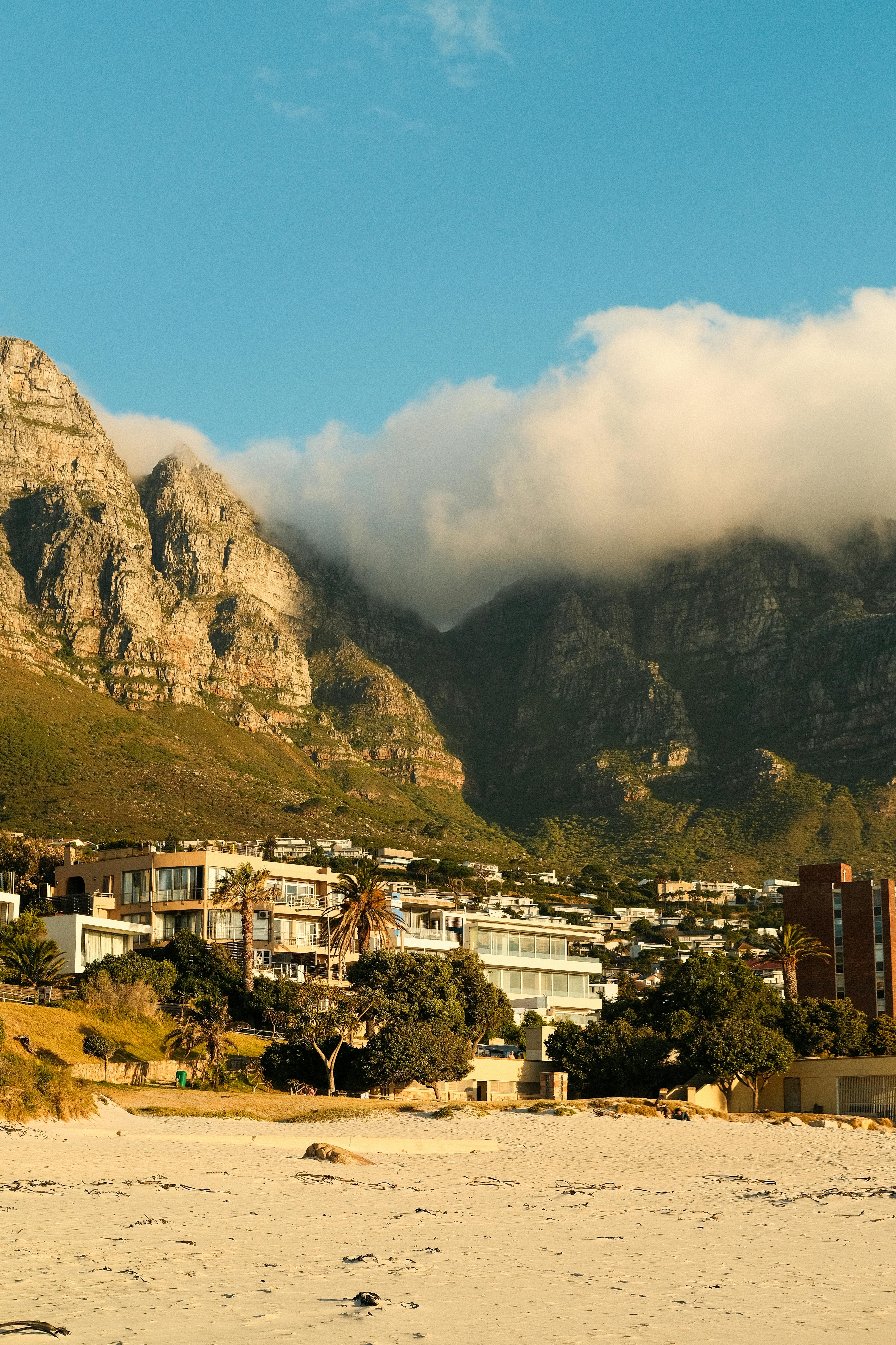 Breathtaking view of the Twelve Apostles in Cape Town with beach and clouds.