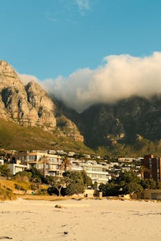 Breathtaking view of the Twelve Apostles in Cape Town with beach and clouds.