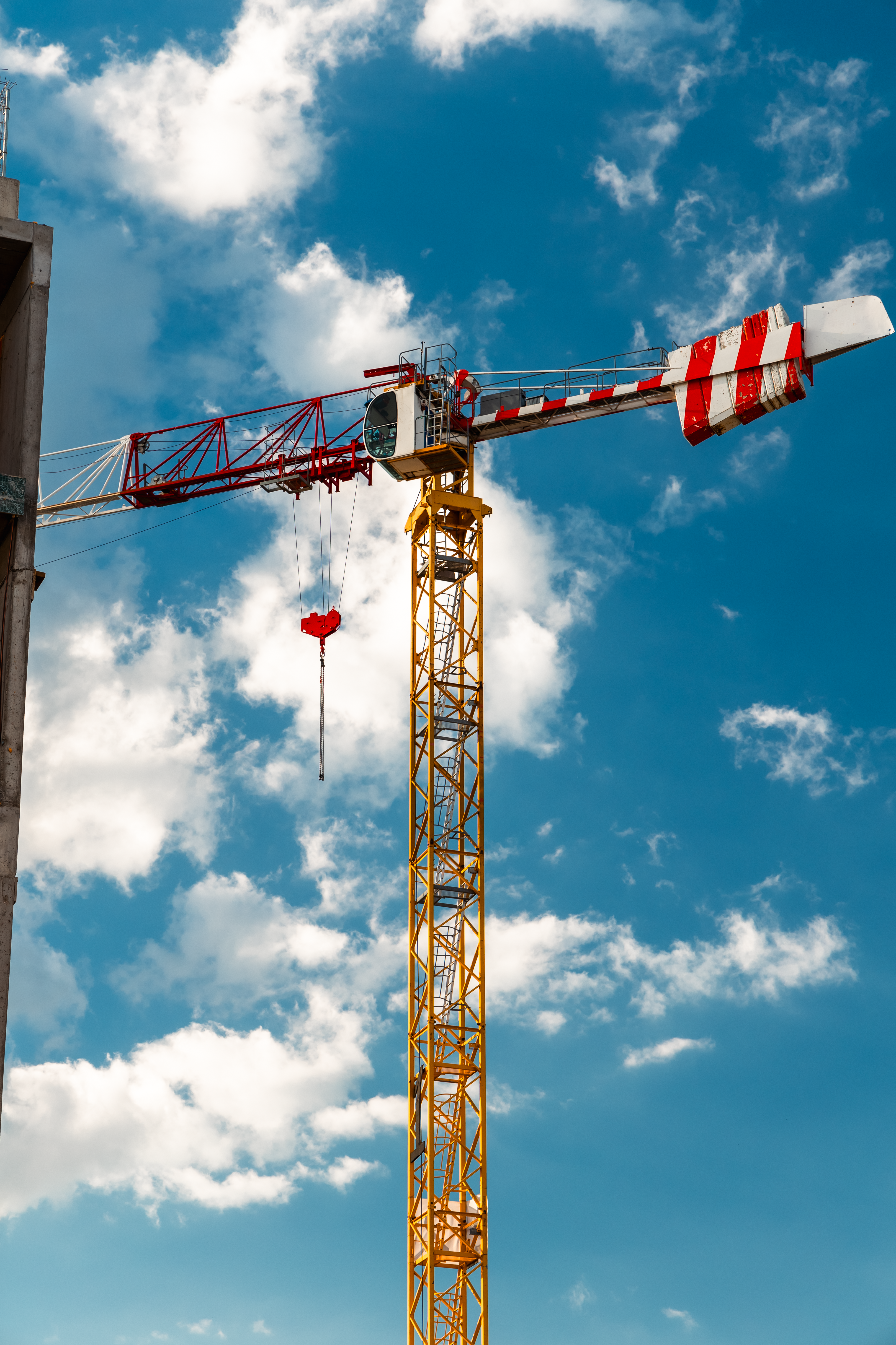 Tower Crane Against Blue Sky with Clouds · Free Stock Photo