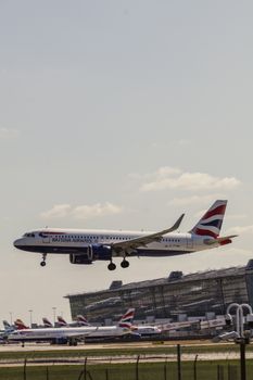A British Airways plane descends for landing at London's Heathrow Airport on a clear day.
