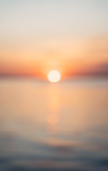 Serene blurred ocean sunset with soft warm tones, perfect for relaxation themes.