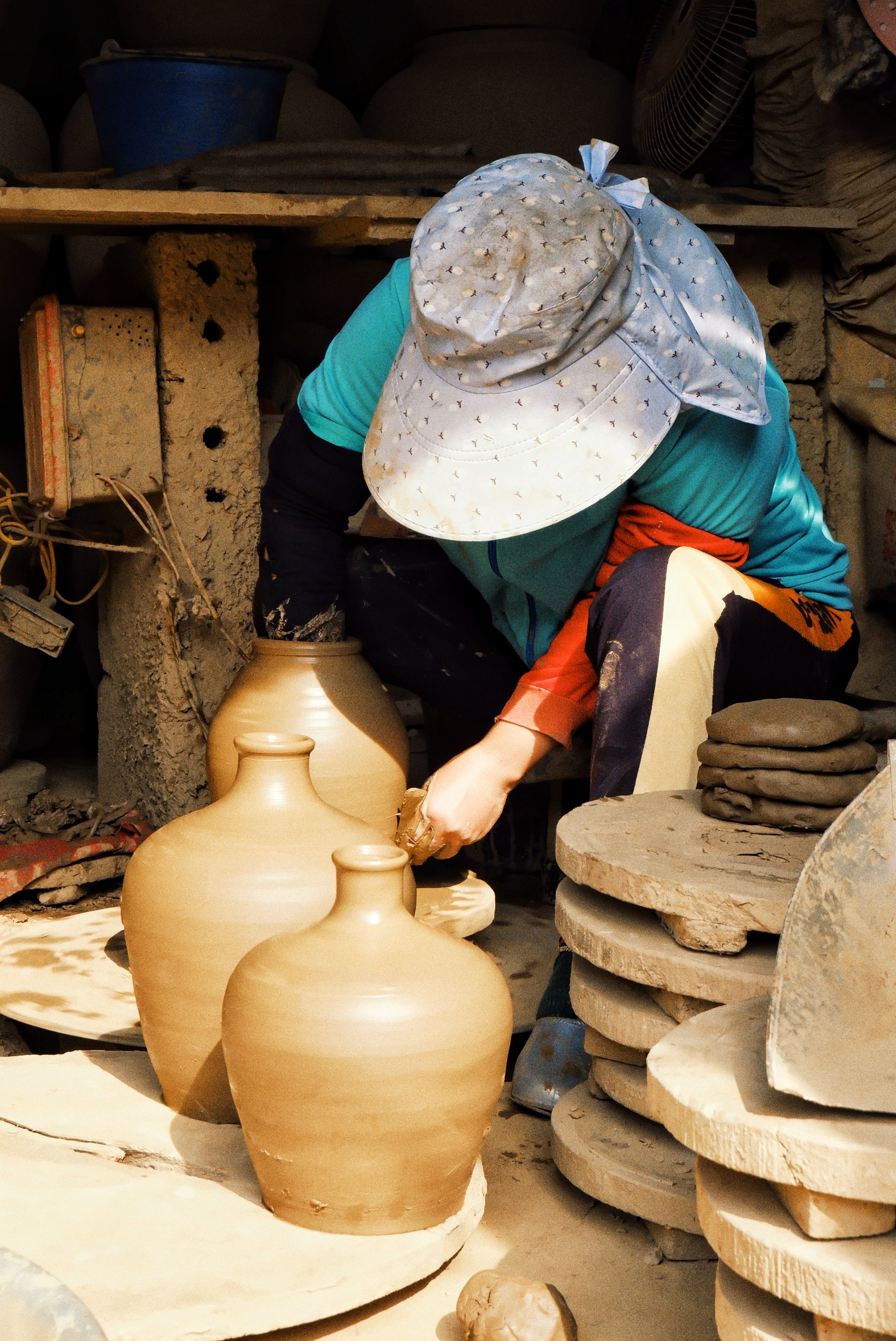 Traditional craft village in Quang Ninh Vietnam, artisan hands shaping pottery and weaving bamboo, authentic workshop environment, natural light, local culture details, highly detailed realistic travel documentary