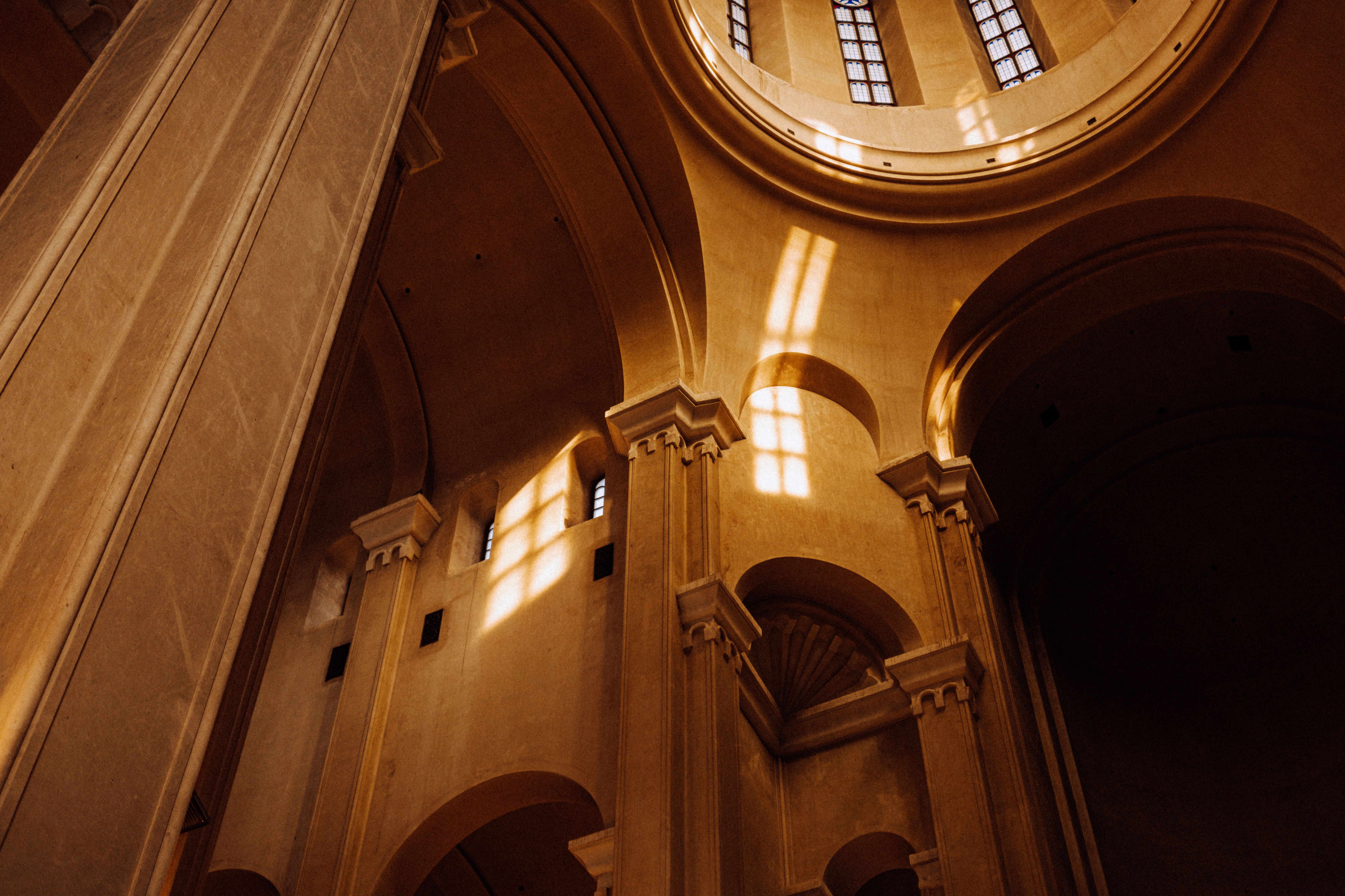 Dramatic sunlight casting shadows inside a Tbilisi cathedral. (Photo by Ata Ebem on Pexels)