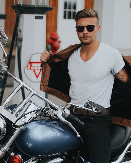 Man Wearing White Crew-neck T-shirt Sitting on Motorbike