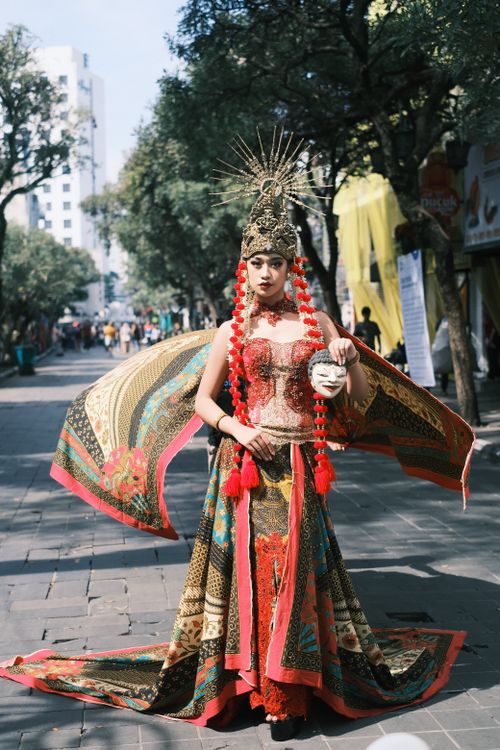 Free Woman in traditional Indonesian attire on busy urban street in West Java. Stock Photo