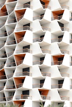 A striking geometric apartment facade with orange accents in Dubai, UAE.