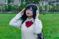 Young Woman in Headphones Enjoying Music Outdoors