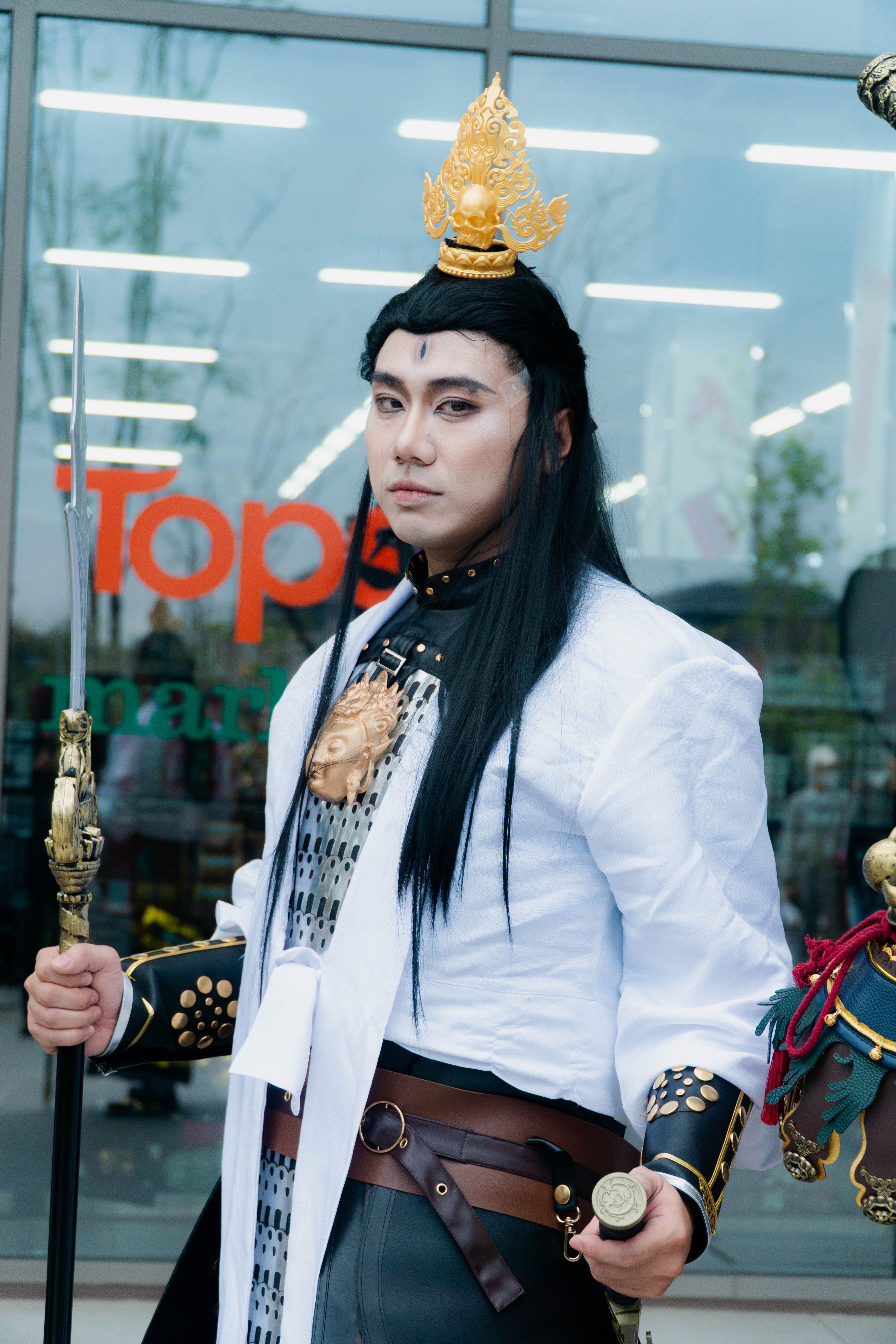 Person in traditional warrior costume with intricate details outside a store.