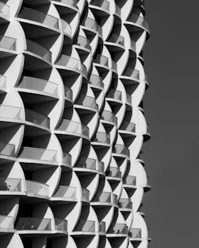 Black and white photo of a unique architectural facade in Dubai with curved balconies.