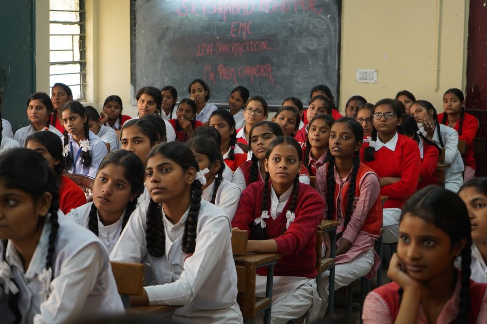 Students raising their hands during a Nova digital literacy class