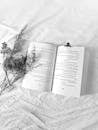 Open Book with Dried Flowers on White Linen